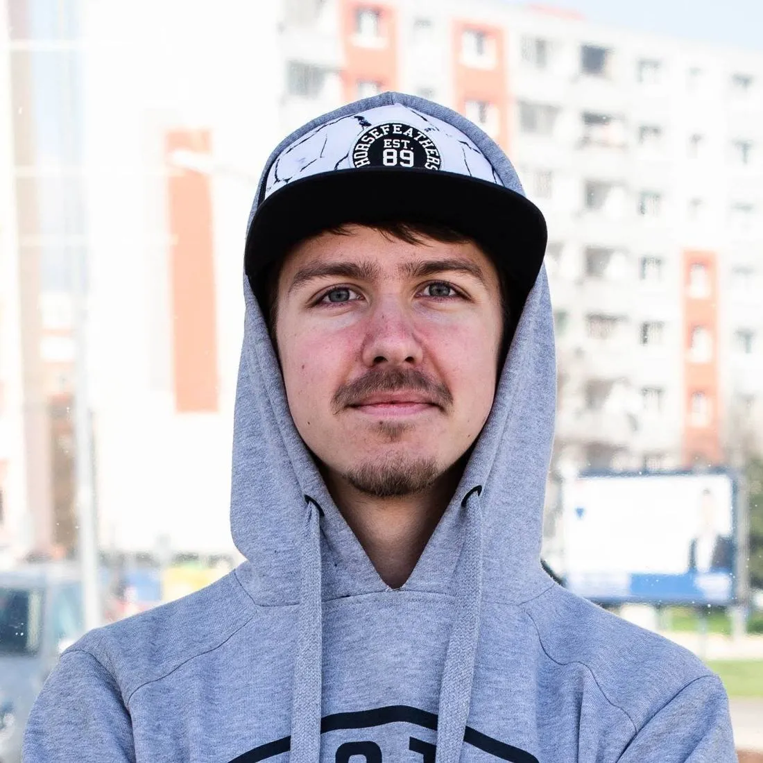 Portrét Patrika Árendáse v mikině a kšiltovce